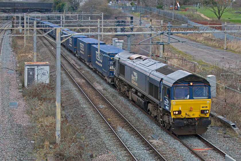 66126, 12.41 DIRFT-Tilbury (4L48, 13E), site of Roade station 
 DRS' 66126 leads the 12.41 DIRFT (Daventry) to Tilbury 4L48 'Tesco Express' past the site of Roade station. This formally regular-as-clockwork train has been a little more sporadic of late, on Sundays at least so it was good to see it running today. 
 Keywords: 66126 12.41 DIRFT-Tilbury 4L48, site of Roade station DRS Tesco express