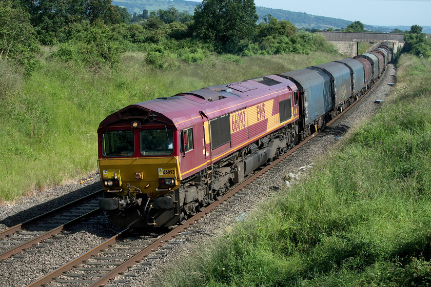 66093, 11.52 Margam-Round Oak (6M41), Croome Perry Wood SO900459 
 Mike and I had been tracking the progress of the 6M41 11.52 Margam to Round Oak coiled steel train since it approached Gloucester some thirty-five miles south of us here at Croome Perry Wood. Luckily, it made reasonable progress and it continues north with 66093 leading the train. Notice that the late afternoon sun is just beginning to illuminate the front of the locomotive, given another thirty minutes and it would have been fully on the front indicating that this section of the Midland route to Birmingham is going more northwesterly than north. 
 Keywords: 66093 11.52 Margam-Round Oak 6M41 Croome Perry Wood SO900459