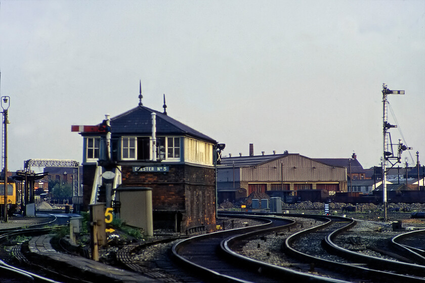 Chester No. 5 signal box (GWR LNWR, 1874) 
 Chester No. 5 signal box was probably the least busy of all the boxes in the vicinity of the station and the various junctions that surrounded it. It was located on the Birkenhead line at the point where the avoiding lines from Chester No. 6 joined (that I sadly never got to see and was so close to where I stood to take this photograph). No. 5 box was different to all the others being one jointly commissioned by the GWR and LNWR being built in 1874. It was extended twice during its life in both 1908 and 1915 with evidence of this work seen in this photograph. I am not at all sure how I managed to get this photograph but I will probably have scrambled down the embankment from Brook Lane's bridge. Notice the Chester wagon works in the background to the right and the diesel depot to the left that the signal box controlled moved to and from. 
 Keywords: Chester No. 5 signal box number 5 no5