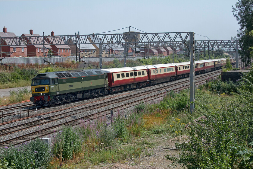 47501 & 90002, 12.07 London Euston-Crewe HS (5Z40, 12E), site of Roade station 
 Having seen this train work up to London earlier in the morning it is seen returning to Crewe as the 5Z40 12.07 ex Euston past the site of Roade's former station. D1944/47501 'Craftsman' is now leading the stock with 90002 'Wolf of Badenoch' at the rear. On the hottest day of the year (and the hottest recorded in the UK for that matter) the driver will be missing air conditioning in the cab of the Class 47, not somthing ever installed back in 1966 when it was constructed at Crewe! 
 Keywords: 47501 90002 12.07 London Euston-Crewe HS 5Z40 site of Roade station Intercity Swallow Wolf of Badenoch Craftsman