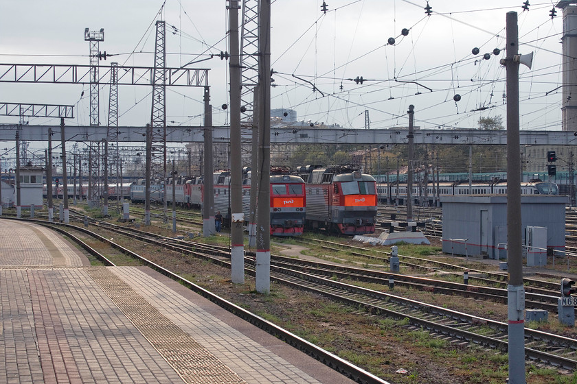 CHS7-025, stabled & CHS7-198, stored Moscow Kiyevsky station yard 
 It's a long time since I've seen so many Skodas in a line! Just outside of Moscow's Kiyevsky station is a line of CHS7 locomotives, built by Skoda at their Lenin plant in Plzen located in the Czech Republic. They were constructed between 1983 and 1999 into various sub-classes but the CHS7s remain almost Russia's most powerful electric locomotives. However, CHS7-198, to the right in this lineup, has its windscreens boarded over and looks as though it may be in some kind of storage. I am not sure if its neighbours, staring off with CHS7-025, are in the same situation or not? 
 Keywords: CHS7-025 CHS7-198 Moscow Kiyevsky station yard