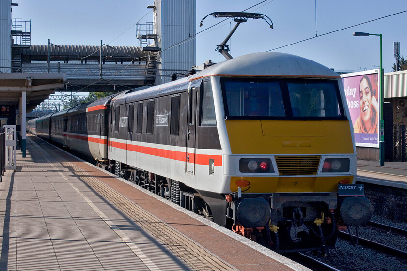 90002, 07.00 Manchester Piccadilly-London Euston (1Z93, 4L), Bletchley station 
 90002 'Wolf of Badenoch' pushes at the rear of the 1Z93 LSL operated 07.00 Manchester to Euston relief service. The train is seen at line speed passing through Bletchley station on a fine if somewhat chilly September morning. With the opportunity to travel aboard an exclusively first-class train for a reasonable set fare passengers heading to and from London have the opportunity of sampling rail travel at its best. By that, I mean in a Mk. III coach sitting in a comfortable and roomy seat placed to offer unrestricted viewing that is far superior to those fitted to Pendolinos and most other new trains for that matter! 
 Keywords: 90002 07.00 Manchester Piccadilly-London Euston 1Z93 Bletchley station Intercity Swallow Wolf of Badenoch