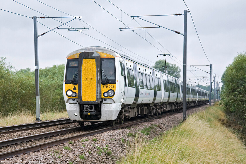 379008 & 379030, LE 11.04 Cambridge-London Liverpool LS (2H25), Sawston foot crossing TL479486 
 379008 and 379030 head south past a small foot crossing just south of Sawston in Cambridgeshire. The pair of Abellio Greater Anglia Electrostars are working the 2H25 11.04 Cambridge to Liverpool Street service. The photograph is taken from the security of a swing gate that protects pedestrians at the footpath crossing. 
 Keywords: 379008 379030 11.04 Cambridge-London Liverpool LS 2H25 Sawston foot crossing TL479486