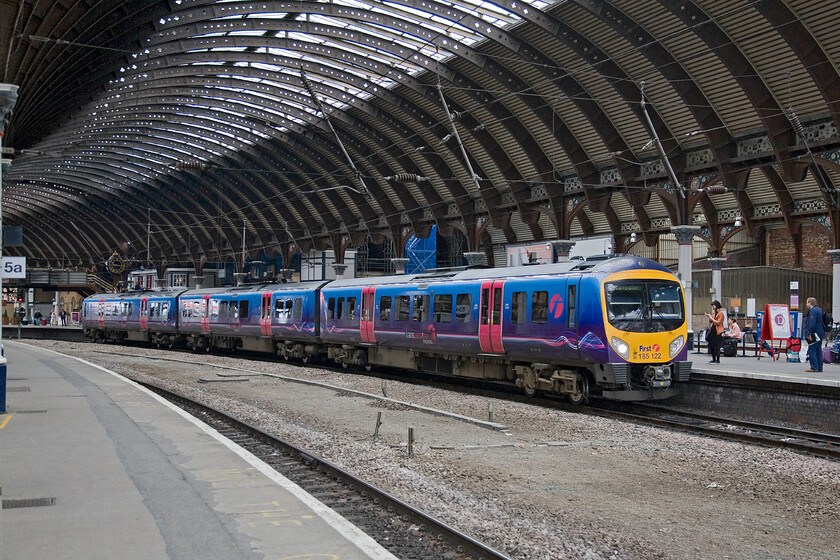 185122, TP 08.06 Newcastle-Liverpool Lime Street (1F64), York station 
 The 08.06 Newcastle to Liverpool Lime Street TPE service stands under York's magnificent station roof worked by 185122. I cannot help but feel that the space between the bi-directional lines that once was occupied by two other tracks spoils the station somewhat but economical expediency rules the day I suppose. 
 Keywords: 185122 08.06 Newcastle-Liverpool Lime Street 1F64 York station TransPennine Express TPE