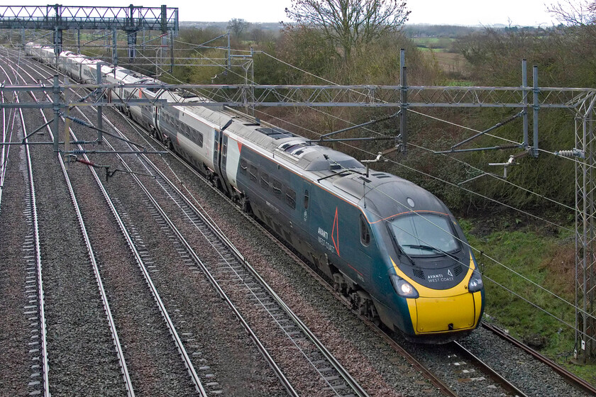 390123, VT 07.43 London Euston-Liverpool Lime Street (1F12 4L), Castlethorpe SP790453 
 390123 works the 07.43 Euston to Liverpool Avanti service just north of the Buckinghamshire village of Castlethorpe. After the earlier rain, the sky is beginning to lighten up making a pleasant change from the weather of late. 
 Keywords: 390123 07.43 London Euston-Liverpool Lime Street 1F12 Castlethorpe SP790453 AWC Avanti West Coast Pendolino