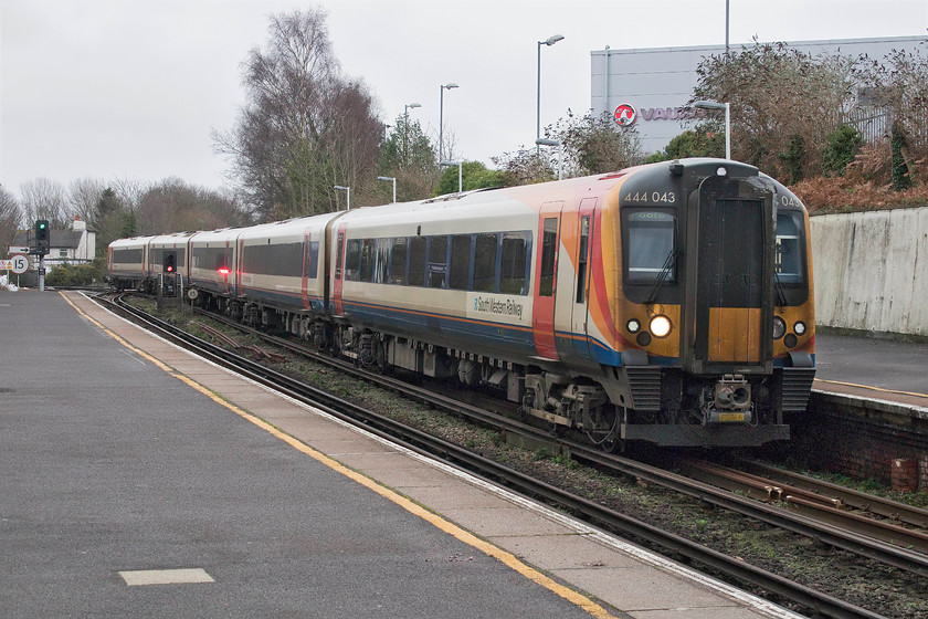 444043, SW 10.39 London Waterloo-Poole (2B27, 1L), Branksome station 
 444043 slows for its stop at Branksome station working the 10.39 Waterloo to Poole that will soon reach its destination in two stops' time. The junction under the rear coach of the unit is where the former Somerset and Dorset line left the London and South Western metals to its southern terminus at Bournemouth West station. This station was closed after the electrification was completed in the summer of 1965. Today, the site of the station is occupied by the Queens Road car and coach carpark. However, part of the trackbed leading to the terminus is still in use as the home to Bournemouth's train care depot with the units accessing the depot via the junction that involves a rather complicated crossover and reversal. 
 Keywords: 444043 10.39 London Waterloo-Poole 2B27 Branksome station South Western Railway SWR