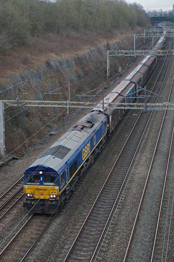 66797, 06.53 Dollands Moor-DIRFT (6M41, 1L), Roade cutting 
 Two days ago I photographed the same train hauled by the same locomotive but from the bridge seen in the background in Roade cutting. However, the weather is very different today with no sun and a lot colder. Wearing its one-off GBRf livery 66797 leads the 6M41 06.53 Dollands Moor to Daventry water train. 
 Keywords: 66797 06.53 Dollands Moor-DIRFT 6M41 Roade cutting GBRf