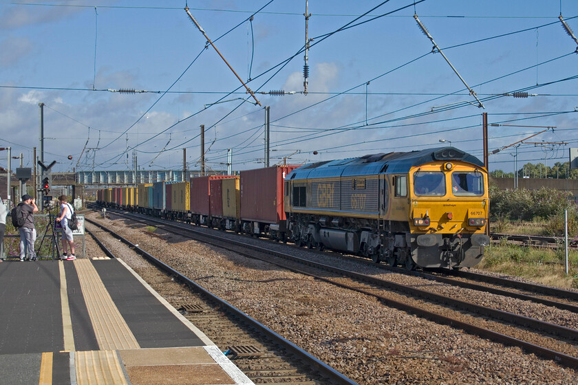 66707, 05.21 Masborough-London Gateway (4L98, 6L), Peterborough station 
 Unfortunately, taken on the wrong side for the sun GBRf's 66707 'Sir Sam Fay' gathers speed through Peterborough station leading the late running 4L98 05,21 Masborough to London Gateway intermodal service. The train had been waiting to the north of the station in the GBRf yard for some time getting underway well over thirty minutes late, time that it made up arriving just six adrift. 
 Keywords: 66707 05.21 Masborough-London Gateway 4L98 Peterborough station Sir Sam Fay