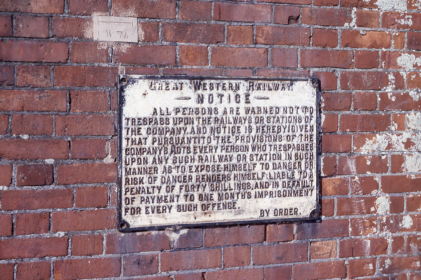 Former GWR cast sign, Stoke Canon signal box 
 A superb former GWR cast sign attached to the brickwork of Stoke Canon signal box. The 1874 Bristol and Exeter Railway signal box which had been retained to operate the level crossing was not closed until 09.12.85 and still stands at this spot but in a parlous state with the windows boarded up. Not unsurprisingly, the sign is not on the wall any more but using Google Street View reveals its former location given away by some different coloured bricks and, even more incredibly, that the November 1976 cement test strip is still on the wall of the box and intact indicating no movement of the structure during the intervening forty-five years! It really is time that the box is rescued before the inevitable occurs - be that of collapse or an arson attack. 
 Keywords: Former GWR cast sign Stoke Canon signal box