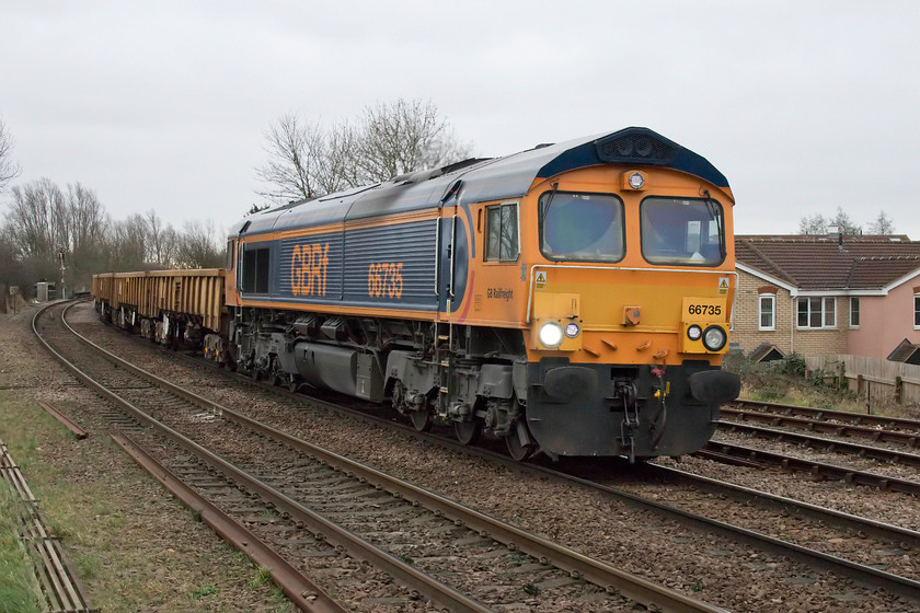 66735, 14.05 Harlow Mill-Whitemoor Yard (6T01), March East Junction level crossing 
 GBRF's 66735 brings the 14.05 Harlow Mill to Whitemoor Yard infrastructure train past March East Junction level crossing. This 66 arrived in the UK in 2003 and, until 2011, it carried a DRS livery. 
 Keywords: 66735 14.05 Harlow Mill-Whitemoor Yard 6T01 March East Junction level crossing