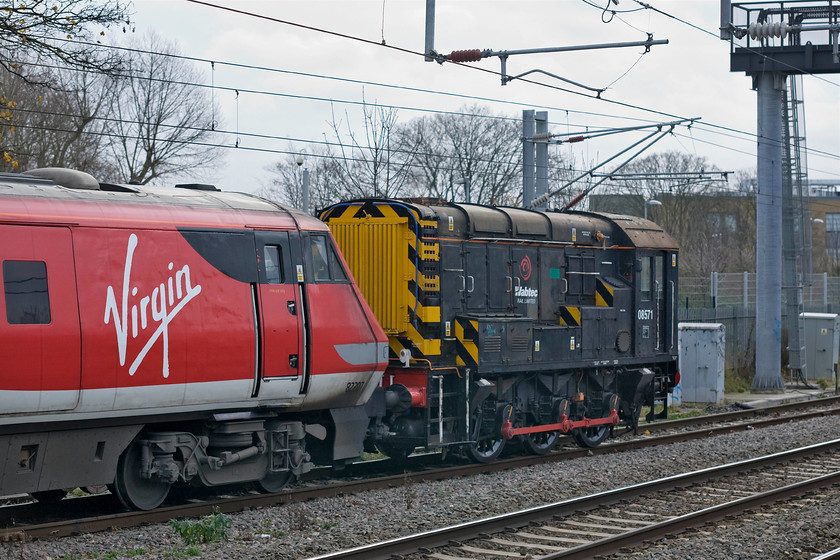 08571 & 82207, ECS shunting move, out and in to Bounds Green TMD, Alexandra Palace station 
 Bounds Green depot is just a short distance north of Alexandra Palace station with access to the facility via a single service road to the east of the station and the down slow. In this manoeuvring move resident shunter, 08571 brings 82207 and a set of Mk. IV stock out of the depot and then, as a short time later return it again. 08571 is owned and operated by Wabtec Rail Limited based at Doncaster and looks very smart in their all-black livery. It entered service in June 1959 as D3738 and spent all of its working life at various Scottish depots until coming south in more recent years. 
 Keywords: 08571 82207 shunting Bounds Green TMD Alexandra Palace station Wabtec Virgin East Coast VTEC