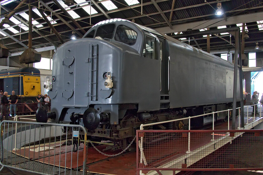 D5910, on display, Barrow Hill Roundhouse 
 The team working to recreate one of British Railways' early and least successful designs that were later dubbed the Baby Deltic (later to become Class 23) is progressing well based on the appearance of their efforts located on Barrow Hill's roundhouse turntable. However, the former and heavily modified Class 37 body, now numbered D5910, is really no more than a shell with a huge amount of work needed to prepare and fabricate the interior before any thoughts about reinstalling the unique nine-cylinder Napier engine. The group who is undertaking this work have done an amazing job so far to recreate this long-forgotten, fascinating and unique piece of railway history. 
 Keywords: D5910 on display Barrow Hill Roundhouse Baby Deltic