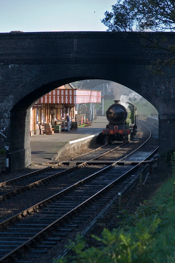 8572, Weybourne-Sheringham LE working, Weybourne station 
 Framed by Sandy Hill Lane overbridge 8572 waits to leave Weybourne 'wrong line' having been prepared for its day's work in the yard at the other end of the station. It will work tender-first light engine to Sheringham station. Once again, I must wax lyrical about the quality of the superb autumn light! 
 Keywords: 8572 Weybourne-Sheringham Light engine working, Weybourne station LNER B12