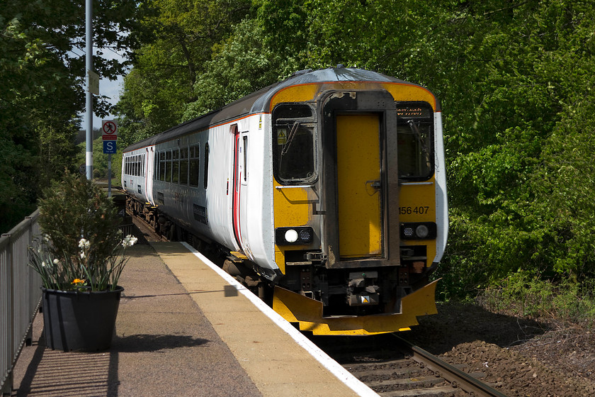 156407, LE 11.44 Sheringham-Norwich (2S13, 1L), Roughton Road station 
 Having worked to Sheringham, 156407 now returns to Norwich with the 11.44 ex. Sheringham. The 2S13 working is seen entering Roughton Road station. This station was opened by BR in May 1985 and is situated in the southern outskirts if Cromer. It has very basic facilities but is well maintained, and at the time of our visit, was having some maintenance and renovations undertaken. 
 Keywords: 156407 2S13 Roughton Road station