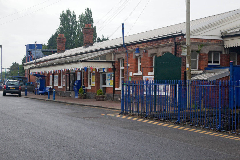 Frontage, Princes Risborough station 
 Complete with bunting adornments, the frontage of Princes Risborough station looks smart and well maintained. It's a typical GWR styled station that originally opened in 1862 at slightly different spot further up the line by The Wycombe Railway. It's a shame that the giant carbuncle of a bridge, seen rising above the building in the background, has spoilt the station somewhat. 
 Keywords: Frontage, Princes Risborough station