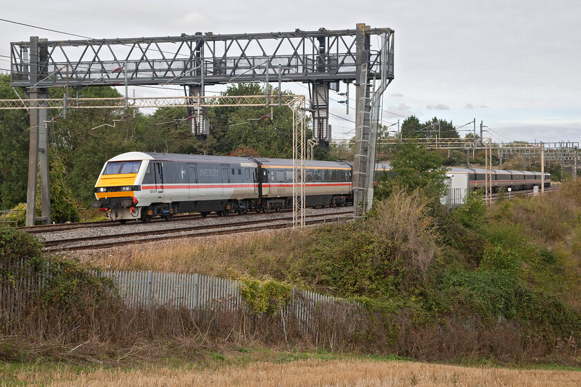 82139 & 90002, 09.00 Manchester Piccadilly-London Euston (1Z93, 7L), between Roade & Ashton 
 DVT 89139 leads LSL's 09.00 Manchester to Euston relief service between the villages of Roade and Ashton. 90002 'Wolf of Badenoch' is seen providing power at the rear of the train. This service was being run in connection with the large increase in travellers resulting from the funeral of the Queen that had just got underway at the time that this photograph was taken. Whilst respecting the death of the monarch, as I would anybody else for that matter, as a staunch Republican I did not join many others watching the day's events unfold on television. 
 Keywords: 82139 90002 09.00 Manchester Piccadilly-London Euston 1Z93 between Roade & Ashton Wolf of Badenoch