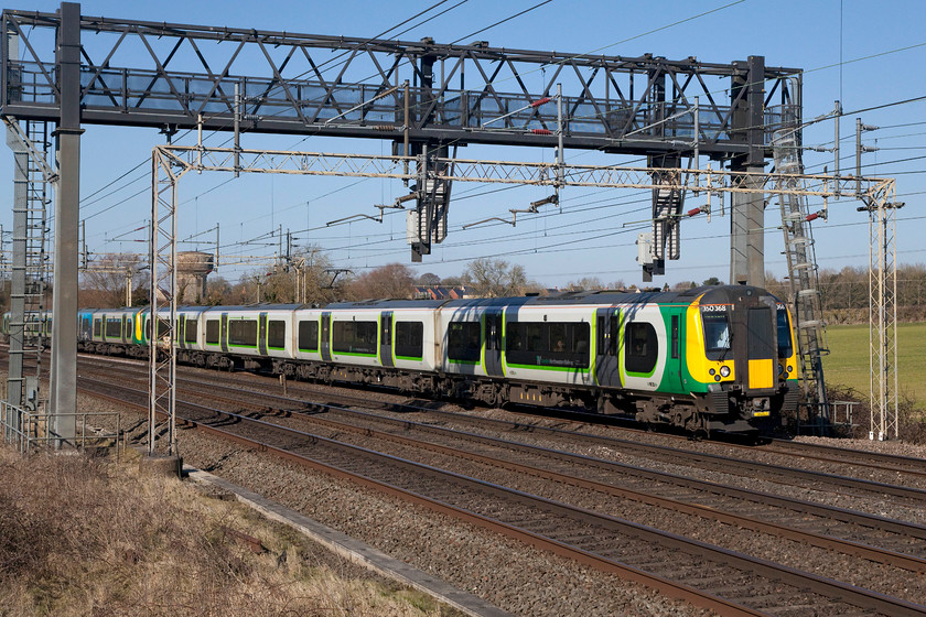 350368, LN 11.14 Birmingham New Street-London Euston (2Y16, 6L), Roade Hill 
 With 350368 leading one of its classmates the 11.14 Birmingham New Street to London Euston passes a classic location between Roade and Ashton on the WCML that I colloquially name as 'Roade Hill'. This spot was a firm favourite with local spotters prior to the scourge of the palisade fencing. Even though the spot can still be utilised, you have to have ladder and some of the angles have been compromised. 
 Keywords: 350368 2Y16 Roade Hill