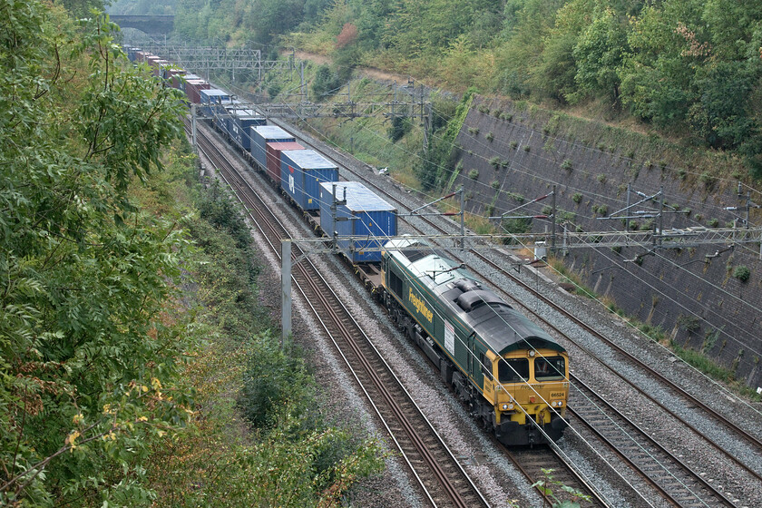 66524, 07.40 London Gateway-Lawley Street (4M41, 25L), Roade cutting 
 66524 heads north through Roade cutting leading the 07.40 London Gateway to Lawley Street Freightliner service. Notice the large vinyl applied to the flank of the locomotive. This has no sort of commemorative value but is merely trying to attract new members of staff to work for Freightliner announcing 'We are recruiting'. I don't know how successful this has been as the locomotive has carried this vinyl since 2018!