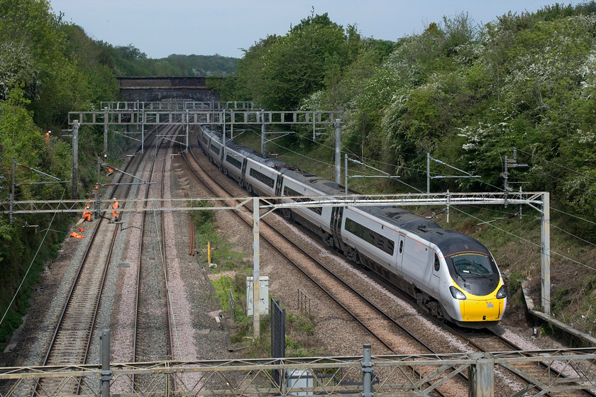 390042, VT 10.45 Wolverhampton-London Euston (1B50, 4L), A508 bridge Roade 
 Due to the COVID-19 induced emergency timetable in place, with a massive reduction of services, Network Rail grasped the opportunity to completely close the Weedon loop between Hanslope and Hilmorton Junctions. Whilst there are occasional Sunday closures of this route it is unprecedented in the week and for several days as is the case now. With the up and down fast lines closed at the southern end of Roade cutting one of a number of workgroups take their lunch break (judging by their complete inactivity during my fifteen minutes on the A508 bridge) in between their work to clear the embankments. This activity would (and should) not really take place during the nesting season but I suppose the opportunity gifted to Network Rail at the present time is too good to miss? 390042 passes on the up slow line with the 10.45 Wolverhampton to Euston 1B50 Avanti West Coast service. 
 Keywords: 390042 10.45 Wolverhampton-London Euston 1B50 A508 bridge Roade Avanti West Coast