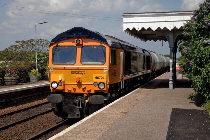 66724, 13.34 North Walsham-Harwich (6A32), Salhouse station 
 The daily working to and from North Walsham passes through Salhouse station. 66724 'Drax Power Station' hauls the long and very heavy 13.34 North Walsham to Harwich liquid condensate tanker train. The condensate is produced from the Bacton Gas Terminal some five miles from North Walsham. This is the only regular freight flow over the Bittern Line and only then on the southern section. 
 Keywords: 66724 13.34 North Walsham-Harwich 6A32 Salhouse station