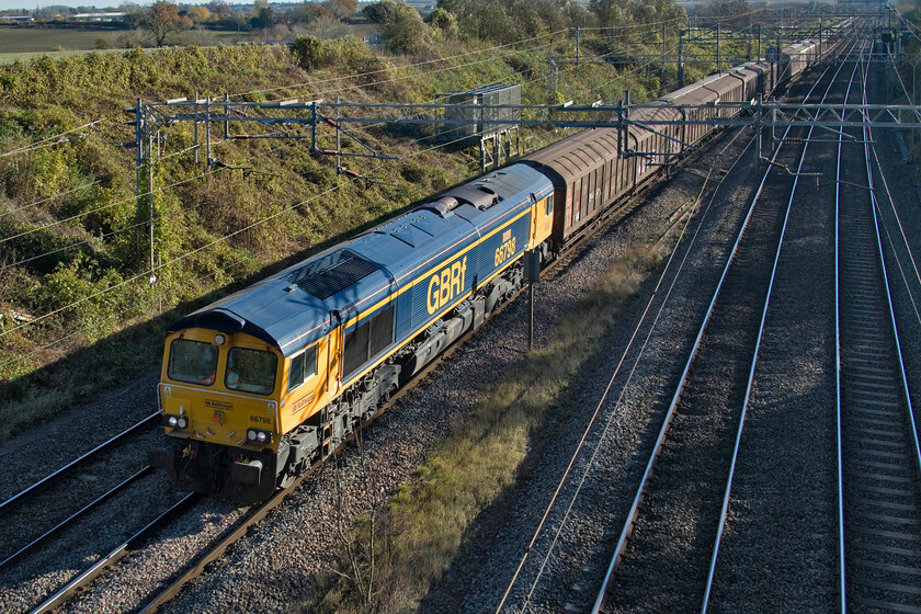 66798, 08.08 Dollands Moor-DIRFT (6M45, 1E), Victoria bridge 
 I superb afternoon lighting 66798 'Justine Langton' passes Victoria bridge just south of Rode leading the daily 'water train' officially the 6M45 08.08 Dollands Moor to Daventry train. I was particularly pleased to see this locomotive as it is my first photograph of it. 
 Keywords: 66798, 08.08 Dollands Moor-DIRFT 6M45 Victoria bridge Justine Langton