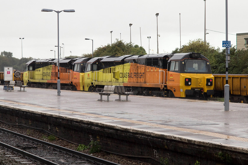 70801 & 70806, stabled, Westbury station 
 The Colas livery of these two class 70s certainly cheers up the grey, drab and wet morning weather at Westbury station. 70801 and 70806 were introduced two years ago and have been put to use on various trains throughout the network. They are noisy locomotives and have a very North American look that wins nothing in the style awards! 
 Keywords: 70801 70806 stabled Westbury station