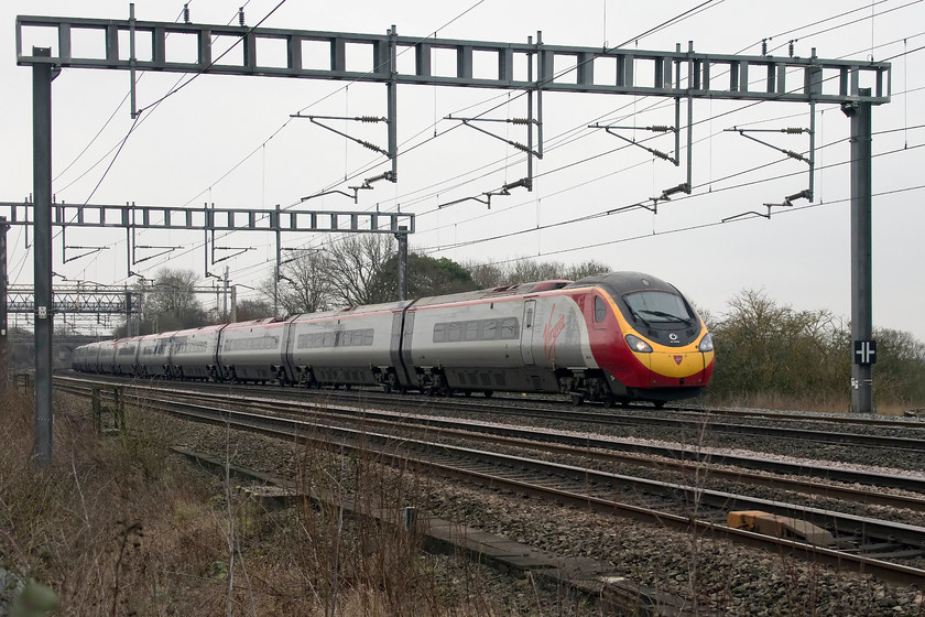 390154, VT 12.40 London Euston-Manchester Piccadilly (1H67, RT), Ashton Road bridge 
 390154 'Matthew Flinders' passes between Roade and Ashton working the 12.40 Euston to Manchester Piccadilly. A terrible day, cold and grey but at least it got me out to help get my 10 000 paces up! 
 Keywords: 390154 12.40 London Euston-Manchester Piccadilly 1H67 Ashton Road bridge