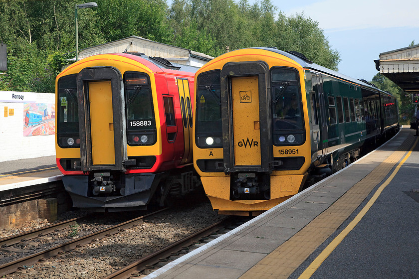 158883, SW 14.56 Salisbury-Romsey (via Southampton) (2R54, 1L) & 158951, GW 14.23 Portsmouth Harbour-Cardiff Central (1F24, 5L), Romsey station 
 Two class 158s meet at Romsey station. Its strange how a different livery makes two identical units look so different! To the left, 158883 operated by SW Trains waits with the 14.56 Salisbury to Romsey via Southampton. Whilst, to the right, 158951 operated by Great Western Railway, leaves with the 14.23 Portsmouth Harbour to Cardiff Central. 
 Keywords: 158883 2R54 158951 1F24 Romsey station