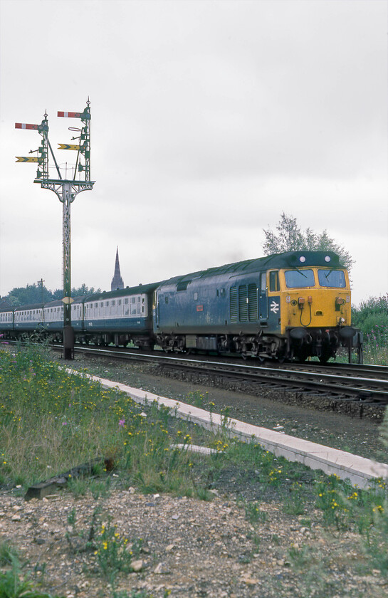 50024, 13.10 London Waterloo-Exeter St. David's, Salisbury West 
 Making further use of my officially issued orange tabard with the associated permissions to get lineside with my camera I have returned from Tunnel Junction to Salisbury West on my trusty bike. With Salisbury cathedral growing from the first coach of the 13.10 Waterloo to Exeter 50024 'Vanguard' gets the train away from the city seen in the West Yard. I am standing on the trackbed of the former GWR route from Exeter that ran parallel to the L&SWR route as far as Wilton Junction until 1973. 
 Keywords: 50024 13.10 London Waterloo-Exeter St. David's Salisbury West Vanguard