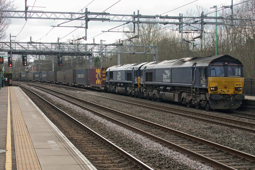 66126 & 66122, 12.16 DIRFT-Mossend Down Yard (4S44, 2L), Atherstone station 
 Having seen the southbound 4M27 in the hands of a very capable Class 88 Andy and I were fully expecting to see the balancing 4S44 12.16 Daventry to Mossend service (for Tesco) also being electric hauled as is normally the case. With availability obviously an issue, DRS have substituted two Class 66s to operate the train, seen passing through Atherstone. 66126 and 66122 would both be powering the train as with just one diesel the service could not keep up to the timings demanded by a Class 88 particularly when it came to Shap and Beatock. 
 Keywords: 66126 66122 12.16 DIRFT-Mossend Down Yard 4S44 Atherstone station DRS Direct Rail Services