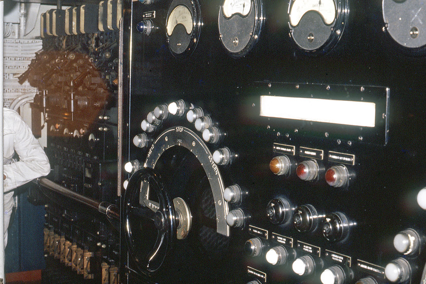 MV Farringford, generator control unit 
 Looking more like a set from Frankenstein this is actually the electrical heart of the MV Farringford. This is how the engines were controlled using the large wheel to allow more electrical power to the paddles that propel the vessel at the command of the bridge. The dials above would have shown the various ampages with the semi-circle of light illuminating to illustrate the power to paddles. Notice the row of huge breakers above the shoulder of the white boiler suited member of the crew watching over me as I take my photograph. 
 Keywords: MV Farringford generator control unit