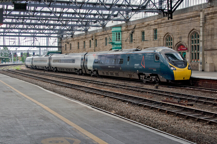 390121, VT 06.43 London Euston-Edinburgh Waverley (9S44, 1E), Carlisle station 
 The service pattern currently being operated by Avanti West Coast is that they run a Glasgow service followed a short time later by an Edinburgh train or vice versa. As Andy and had just alighted from the Glasgow train at Carlisle the 9S44 06.43 Euston to Edinburgh arrives a short time later being worked by 390121. I like Carlisle station with its busy and varied trains. I also have fond memories of spending some time there at unearthly hours during my 1984 Scottish Railrover but these photographs have yet to be scanned and uploaded...maybe in ten years' time, given my present rate of progress on the site but, their time will come! 
 Keywords: 390121 06.43 London Euston-Edinburgh Waverley 9S44 Carlisle station Avanto West Coast Pendolino