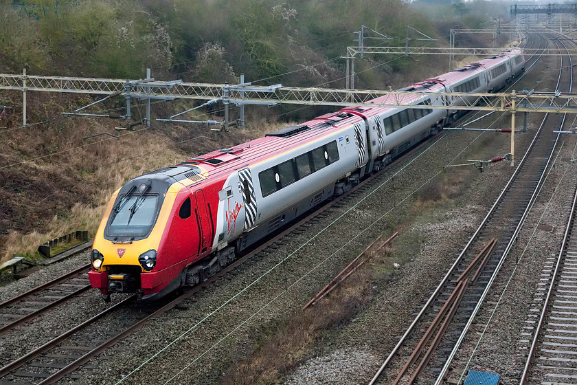 Class 221, VT 13.30 Birmingham New Street-London Euston (1B23), Victoria bridge 
 An unidentified class 221 passes Victoria bridge between Northampton and Milton Keynes with the 13.30 Birmingham New Street to Euston. On such a drab day, the red and silver livery of Virgin Trains really lifts a photograph. 
 Keywords: Class 221 13.30 Birmingham New Street-London Euston 1B23 Victoria bridge