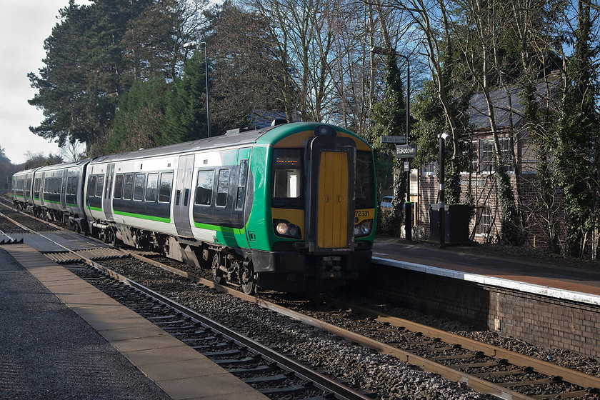 172331, LN 11.55 Kidderminster Dorridge (2C32, 2L), Blakedown station 
 A slightly off-centre picture but for a reason. Through the trees in the background the old signal box can seen. Churchill and Blakedown box closed in 2012 when the line was resignalled. However, the signal box lives on after it was donated to the Parish Council. It was dismantled and moved to it present location from the original one just the other side of the level crossing. It is now used as a village community centre. 172331 is arriving with the West Midlands Railway 11.55 Kidderminster to Dorridge working.