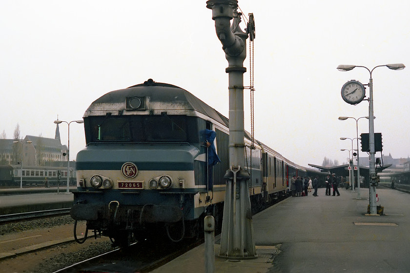 72065, unidentified working, Nantes station 
 SNCF CC 72065 appears to be preparing to leave Nantes station sometime in the early afternoon heading east. Notice the steam age water column on the platform ramp. I had no issues at Nantes station wandering around unchallenged taking photographs. Looking at modern day images from Google Earth, the station and its environs have undergone a huge redevelopment. However, the architecturally interesting spiralled spire in the background still stands atop the building now being home to a branch of Compagnons du Devoir, a training organisation for young people. 
 Keywords: 72065 Nantes station