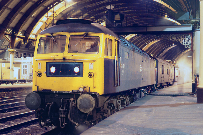 47422 (with LMS van M31061), 21.00 London King's Cross-Edinburgh (1S66), York station 
 47422 has its steam heat boiler tank replenished at York. It was heading the 1S66 SO 21.00 London King's Cross-Edinburgh. At the time this was a Deltic turn so we were somewhat disappointed that it did not produce. However, this shot today represents a piece of history now long gone but one that at the time seemed quite ordinary. Notice the LMS van M31061 behind the locomotive and the ghostly figure of a railwayman supervising the filling of the water tank. The LMS van the BG behind it and the Class 47 have all gone from the railway but the scene on what is now platform 5b is similar apart from the installation of the wires and the loss of the through lines. 
 Keywords: 47422 LMS van M31061 21.00 London King's Cross-Edinburgh 1S66 York station