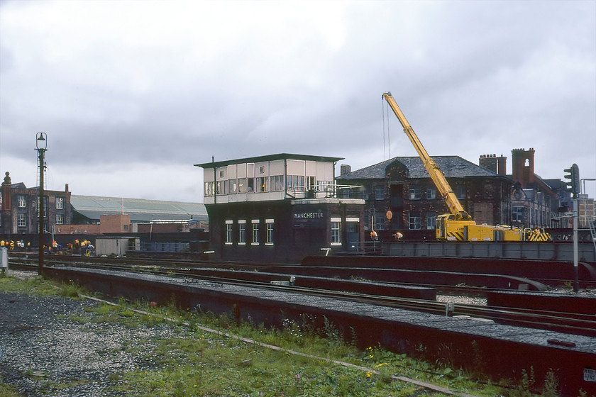 Manchester Deal Street signal box (LMS, 1929) 
 I have spent much time researching this LMS signal box built in 1929. It was located at the western approach to Victoria station with the River Erwell passing underneath the bridge seen in the foreground. The reason for my research was to discover why it was named Deal Street. Even looking back at Victorian street maps of central Manchester reveals no street of that name so its name remains a mystery unless any of my Manchunian readers with local knowledge can advise! The box contained a ninety-nine lever Westinghouse Brake & Saxby Signal Co. Ltd. Style 'K' frame that was in use right up until its closure on 31.07.88 when control was transferred to the Manchester North Signalling Centre. Notice the large BR (LM) enamel sign attached to the front of the box with a large arrow pointing to Victoria station acting almost like a huge and somewhat distanced running-in sign. The land to the right of the photograph was once occupied by Exchange station and, once again, I do not know quite how I got to this particular spot. 
 Keywords: Manchester Deal Street signal box LMS Manchester Exchange