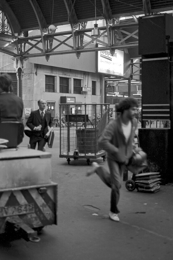 Commuters, London Paddington station 
 I fired off a number of photographs around Paddington station whilst waiting for our train home back to Westbury. Some of these images worked better than others with a number not making it from the rejects box! Here two passengers rush for their train on the concourse negotiating their way through the other workings of the station. Notice the suited passenger clutching his attach case, something any self-respecting commuter would have. Also, notice the large advertisement for the Imperial Life insurance company at the top of the photograph. This company, dating from 1896, is still trading but not under this name that disappeared in 2001 with the company now owned Sun Life Financial of Canada. 
 Keywords: Commuters London Paddington station