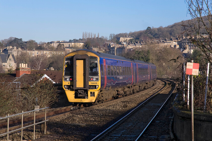 158958, GW 10.50 Great Malvern-Brighton (1O98), Bath Spa station 
 FGW's 158958 leaves Bath Spa and is crossing the River Avon and then about to go over Dolmeads viaduct to the east of the station. The three-car hybrid unit is working the 10.50 Great Malvern to Brighton service a journey that it would be interesting to make in its entirety. 
 Keywords: 158958 10.50 Great Malvern-Brighton 1O98 Bath Spa station