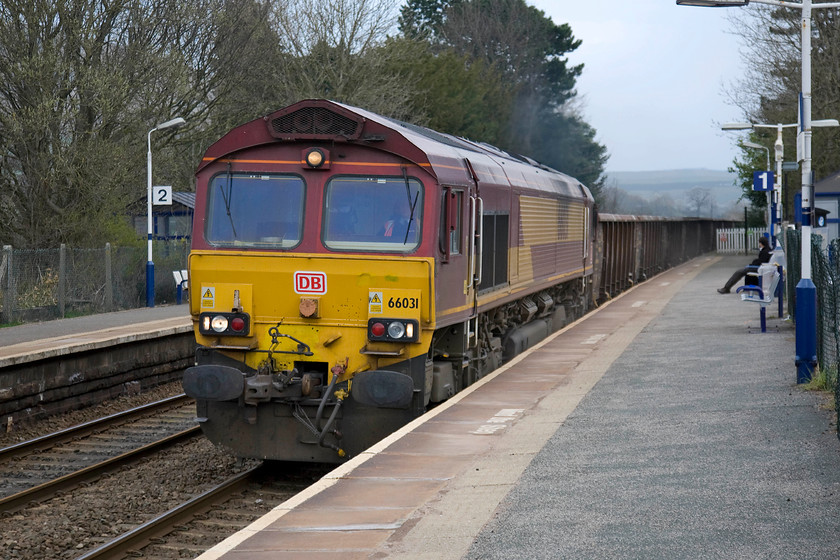 66031, 13.50 Heck Plassmoor-Peak Forest, Edale station 
 66031 shatters the peace at Edale station in the Peak District. It is approaching the end of its journey leading the 13.00 Heck to Peak Forest empty stone wagons. This particular class 66 was a relatively early arrival reaching the UK on 01.12.98. meaning that it approaching twenty year's old! 
 Keywords: 66031 13.50 Heck Plassmoor-Peak Forest Edale station