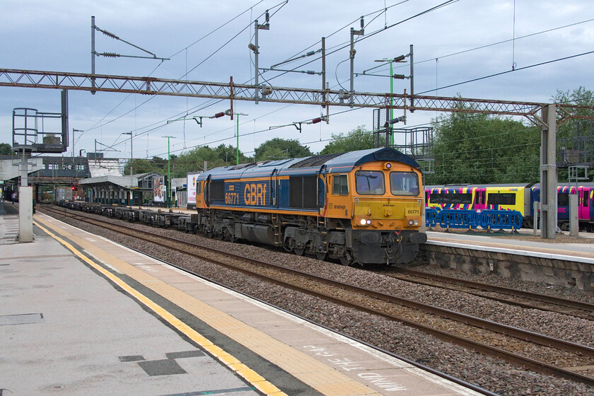 66771, 02.20 Felixstowe South-Birch Coppice (4M01, 15L), Northampton station 
 A smart looking (as they usually are) GBRf 66771 'Amanda' passes northwards through Northampton leading the 02.20 Felixstowe South to Birch Coppice 'liner. Whilst it was still dry here at our starting point for the day out, the clouds in the background look ominous and indeed, within an hour, it was raining heavily, something it did for the rest of the day! 
 Keywords: 66771 02.20 Felixstowe South-Birch Coppice 4M01 Northampton station Amanda