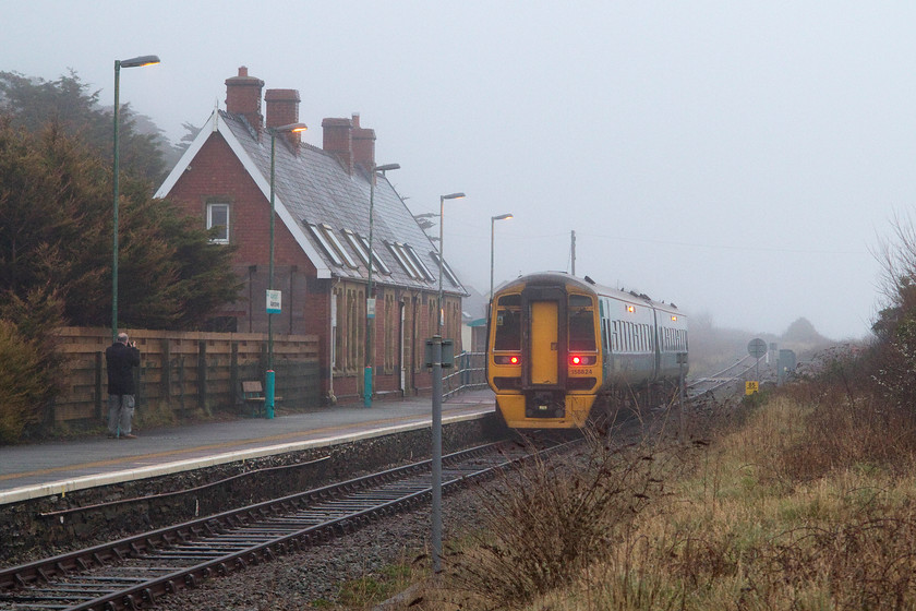 158824, AW 15.37 Pwllheli-Machylleth & Birmingham International (2G65 & 1G65), Aberdovey station 
 Andy takes an equally dismal picture as I have managed at Aberdovey station. As well as rain, the sea mist had started to roll in and this really capped off an utterly appalling day for weather! 158824 is about to leave with the 2G65 15.37 Pwllheli to Machynlleth and Birmingham International. This train will join with an Aberystwyth service at Machynlleth to become the 1G65 for the rest of its journey to the Midlands. 
 Keywords: 158824 15.37 Pwllheli-Machylleth Birmingham International 2G65 1G65 Aberdovey station