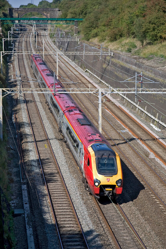 Class 221, VT 10.55 Holyhead-London Euston (1A27), Roade cutting 
 Just a few minutes behind the previous Voyager service another single set heads south through Roade cutting. This time, it is working the 1A27 10.55 Holyhead to Euston Virgin train. 
 Keywords: Class 221 10.55 Holyhead-London Euston 1A27 Roade cutting Virgin West Coast Voyager