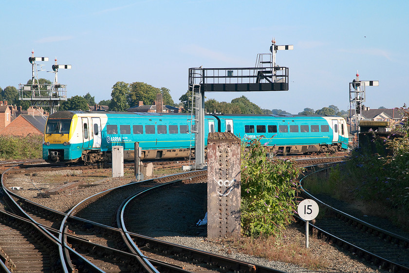 175004, AW 05.03 Carmarthen-Manchester Piccadilly (1W48), Shrewsbury Crewe Junction 
 The 05.03 Carmarthen to Manchester Piccadilly service leaves Shrewsbury station formed by 175004. The signalling and track layout is complicated at the northern end of the station with the signals controlled by Shrewsbury Crewe Junction box. The rather ugly galvanised brackets replaced a superb LNWR gantry that used to span the lines here, see..... https://www.ontheupfast.com/v/photos/21936chg/26146595404/x40113-40144-crewe-campaigner-relief 
 Keywords: 175004 05.03 Carmarthen-Manchester Piccadilly 1W48 Shrewsbury Crewe Junction