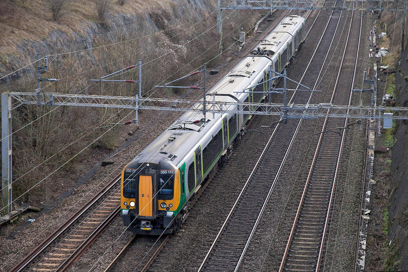 350112, LN 11.54 London Euston-Northampton (2N13, RT), Roade Cutting 
 With just a little light reflecting off the roof of London Northwestern's 350112 as it passes through Roade Cutting. The Desiro is forming the 11.54 Euston to Northampton 2N13 service. 
 Keywords: 350112 11.54 London Euston-Northampton 2N13 Roade Cutting