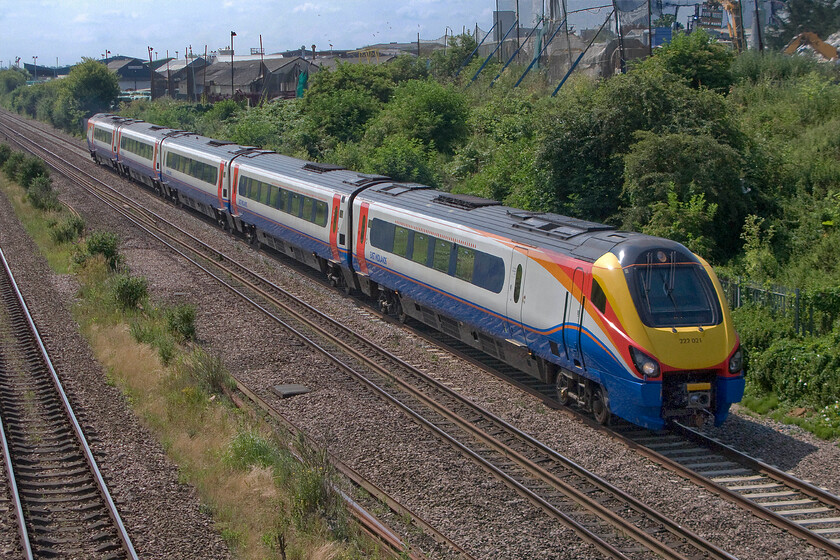 222021, EM 10.01 London St. Pancras-Corby (1M21), Finedon Road industrial estate SP900702 
 In a repeat of the previous photograph, 222021 gets away from its stop at Wellingborough station forming the 10.01 St. Pancras to Corby train. Since their introduction as part of the summer timetable launch in May 2004 the Meridians have been the mainstay of services on the Midland Mainline. They have proved to be reliable units but they are, to the enthusiast at least, a little dull! 
 Keywords: 222021 10.01 London St. Pancras-Corby 1M21 Finedon Road industrial estate SP900702 East Midlands Trains Meridian