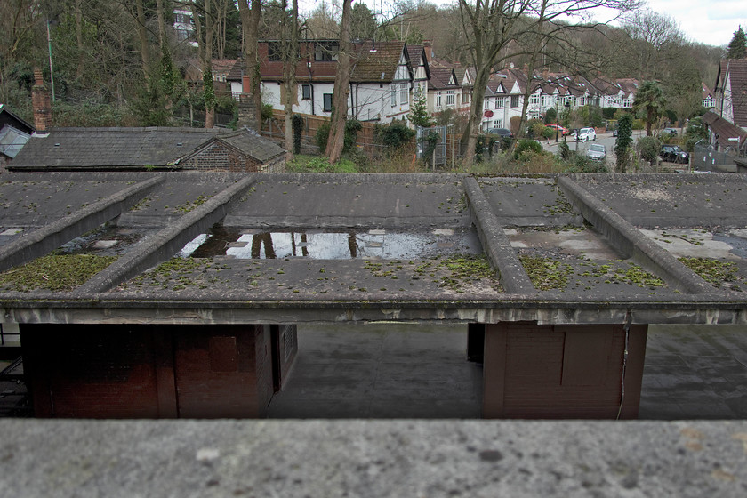 Canopies and platforms, former Highgate station 
 The structure of the long-closed Highgate station is seen over the retaining wall of the London Underground station car park. Access to the former platforms is now all but impossible apart from if one joins one of London Transport Museum's hidden London tours. However, Highgate is not currently on offer but it has been in the past. The last passengers used the station in July 1954 with the tracks remaining in use for a number of years afterwards. The Northern Line passes straight underneath the former station perpendicular to where I am standing. 
 Keywords: Canopies and platforms, former Highgate station