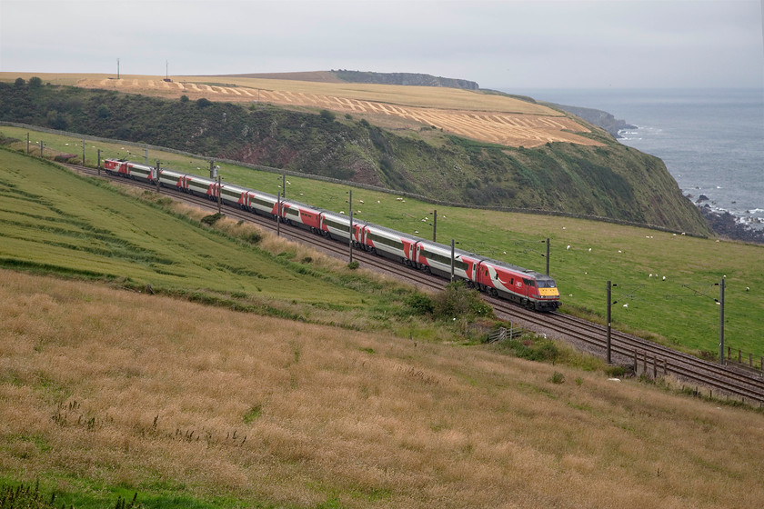 82206 & 91118, GR 13.30 Edinburgh Waverley-London King`s Cross (1E17, 2E), Burnmouth NT956606 
 From an elevated position by the busy A1 road just south of Burnmouth, 82206 leads with 91118 'The Fusiliers' powering at the rear. The train is forming the 13.30 Edinburgh to King's Cross and is seen skirting the North Sea at this dramatic location. I have always wanted to take pictures along this section of track but I would have hoped for better weather than on this particular July day! 
 Keywords: 82206 91118 13.30 Edinburgh Waverley-London King`s Cross 1E17 Burnmouth NT956606