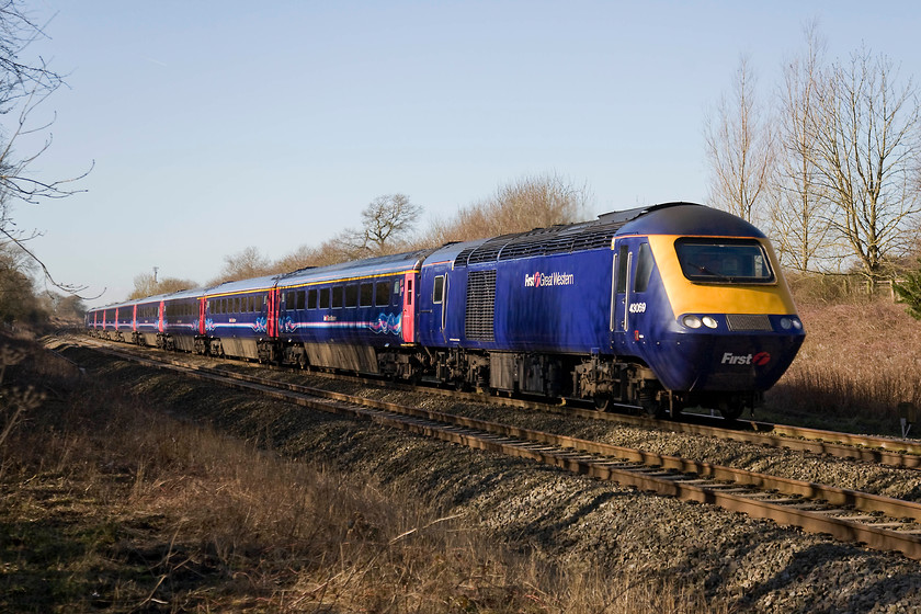 43069, GW 07.40 Paignton-London Paddington (1A12), Knighton crossing SU276890 
 A strange timetabling querk is the 07.40 Paignton to Paddington 1A12 service as seen here. Rather than travelling via Berks. and Hants. route it is timetabled to go via Bristol and Swindon. It is seen passing the site of the former level crossing at Knighton in west Oxfordshire with power car 43069 leading. This classic indigo First Great Western livery looks very smart against the pretty colourless winter background. 
 Keywords: 43069 07.40 Paignton-London Paddington 1A12 Knighton crossing SU276890