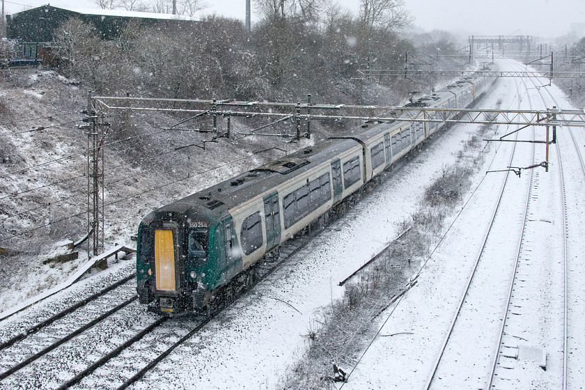 350258, LN 10.53 Birmingham New Street-London Euston (1Y52, 5L), Victoria bridge 
 With the up and down slow lines out of use due to a possession, they remain covered in snow with the fast lines carrying all traffic. 350258 and another unit pass Victoria bridge just south of Roade with the 10.53 Birmingham New Street to Euston diverted away from its usual route through Northampton. 
 Keywords: 350258 10.53 Birmingham New Street-London Euston 1Y52 Victoria bridge London North Western Desiro